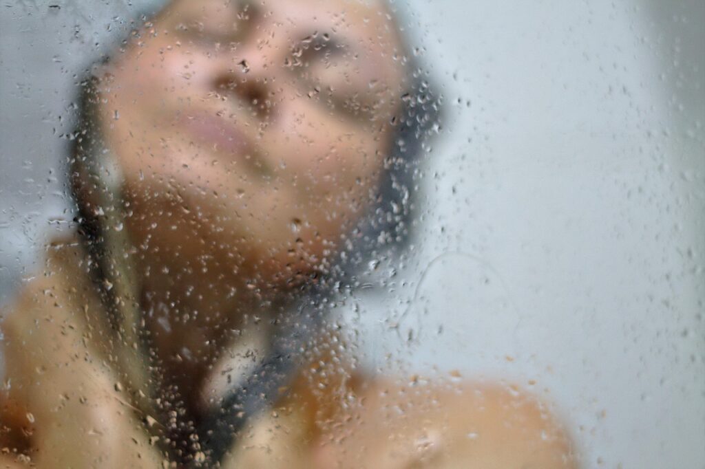 A smiling woman in the shower.