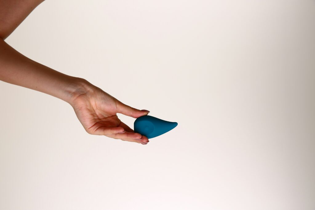 woman holding small blue object