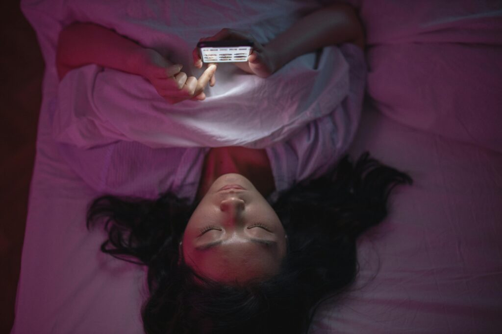 woman in bed with phone