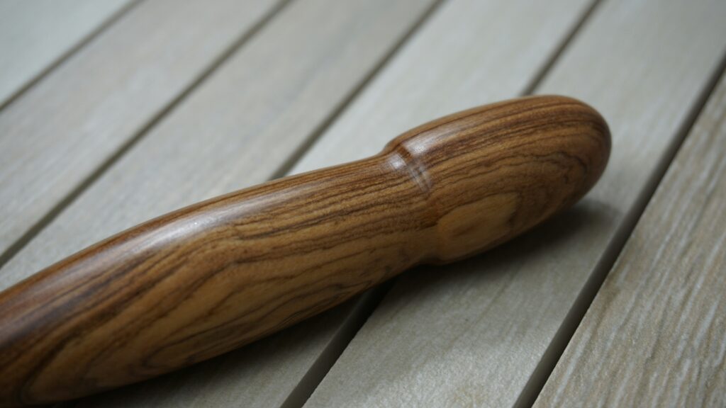 Wooden dildo on wooden table