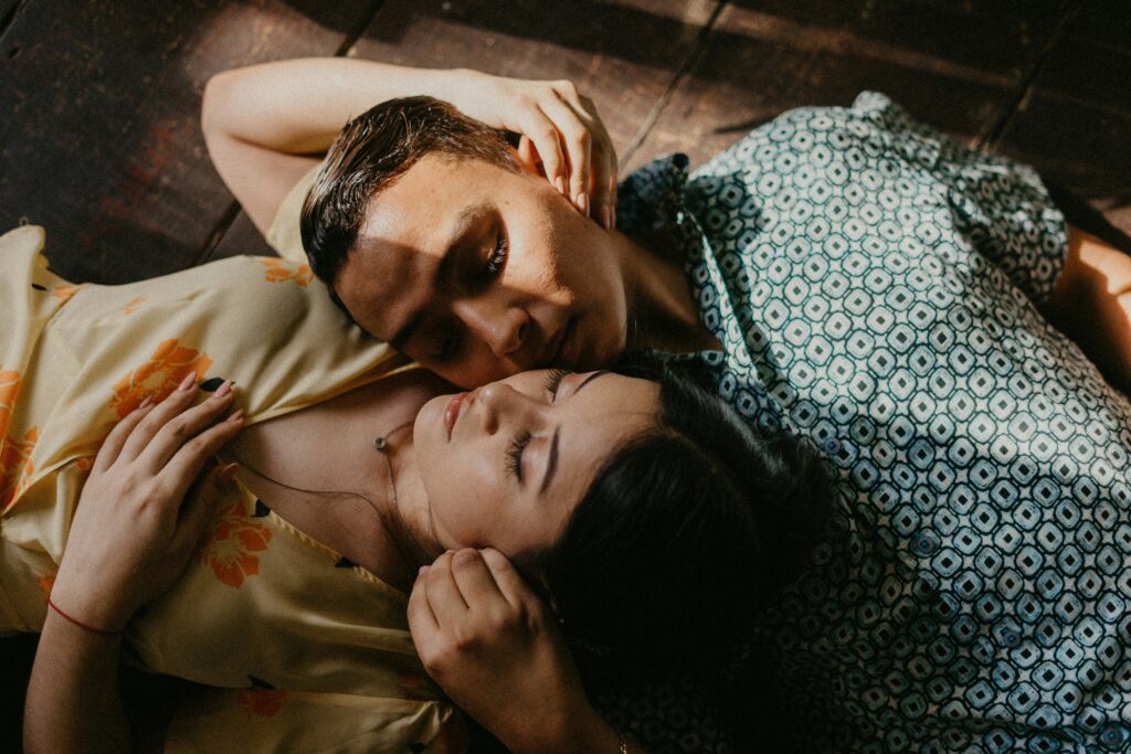 Man and woman lying down and embracing