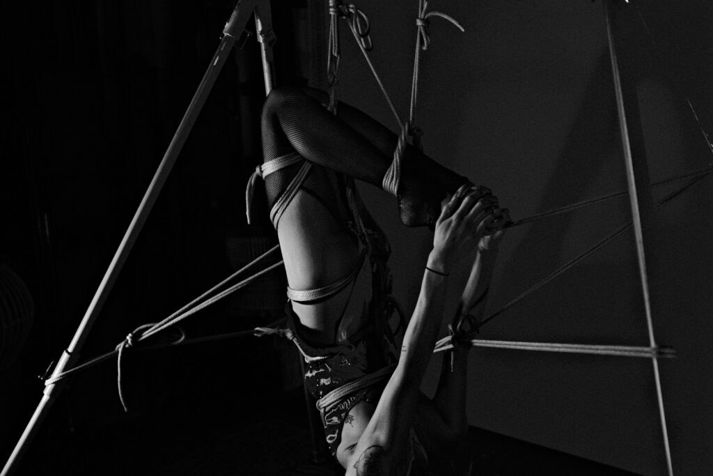 Inverted woman in shibari binds