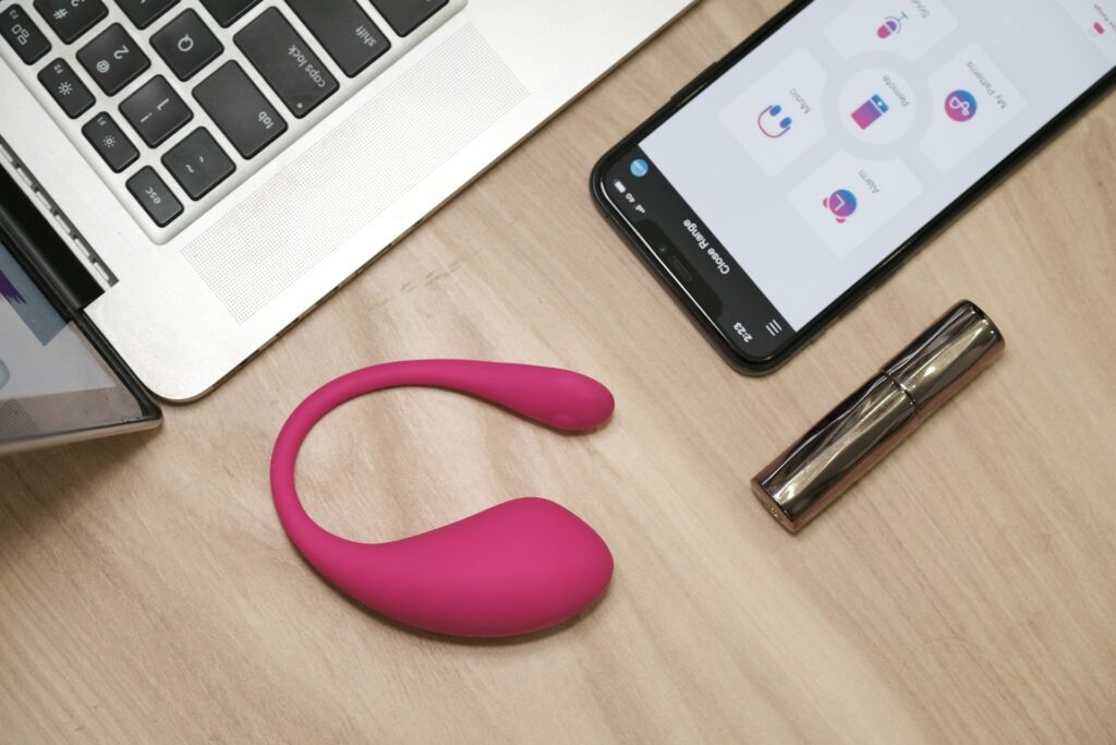 sex toy on desk with phone