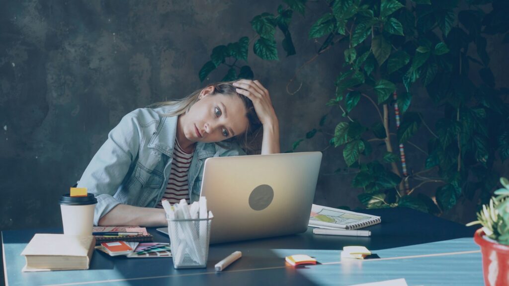 stressed woman working on laptop