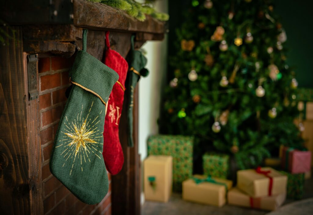 Green and red Christmas stockings by the tree