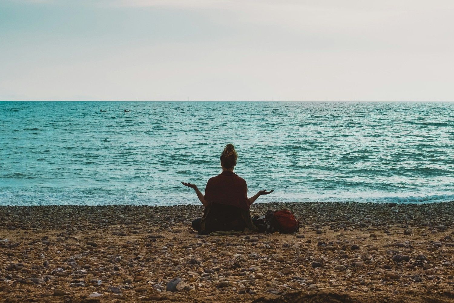 woman meditating on the beach