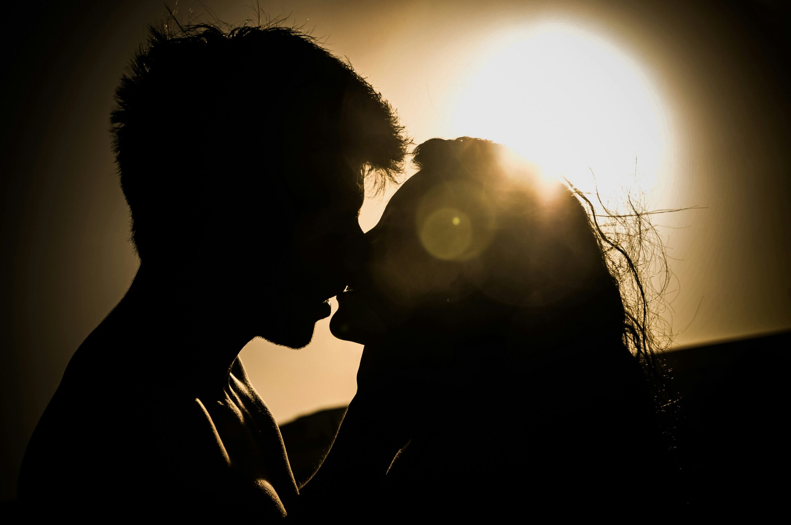 Man and woman kissing in silhouette