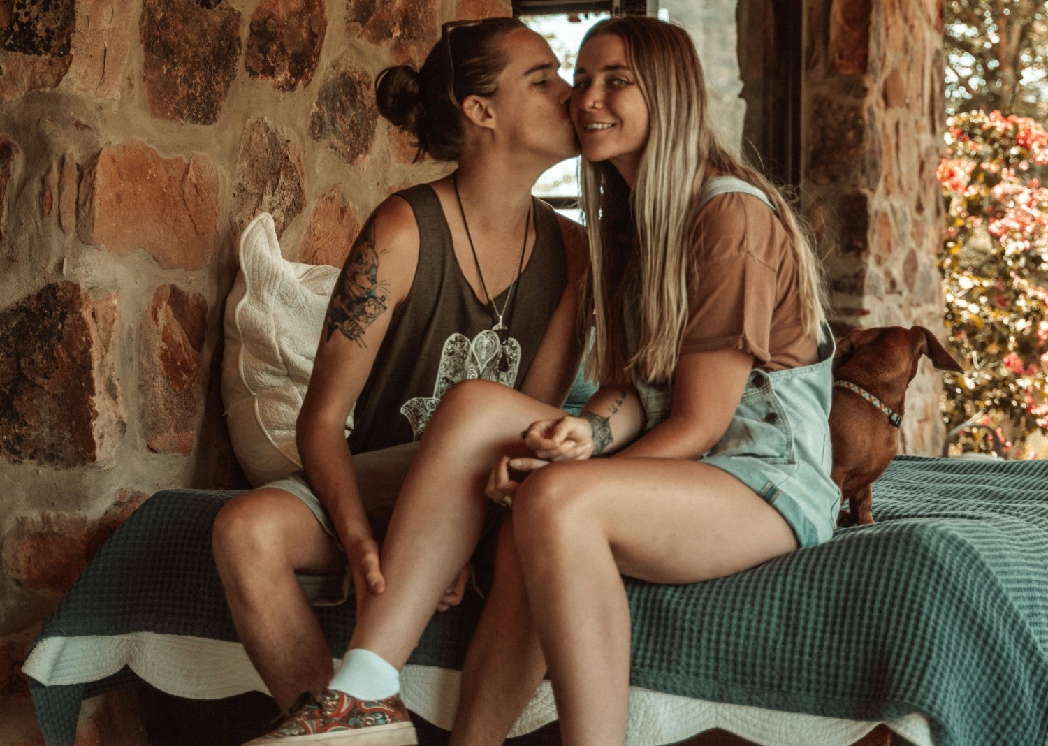 A girl kissing another girl