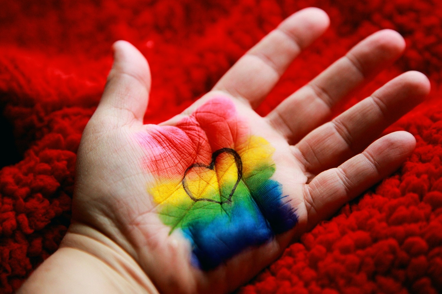 Hand with rainbow heart