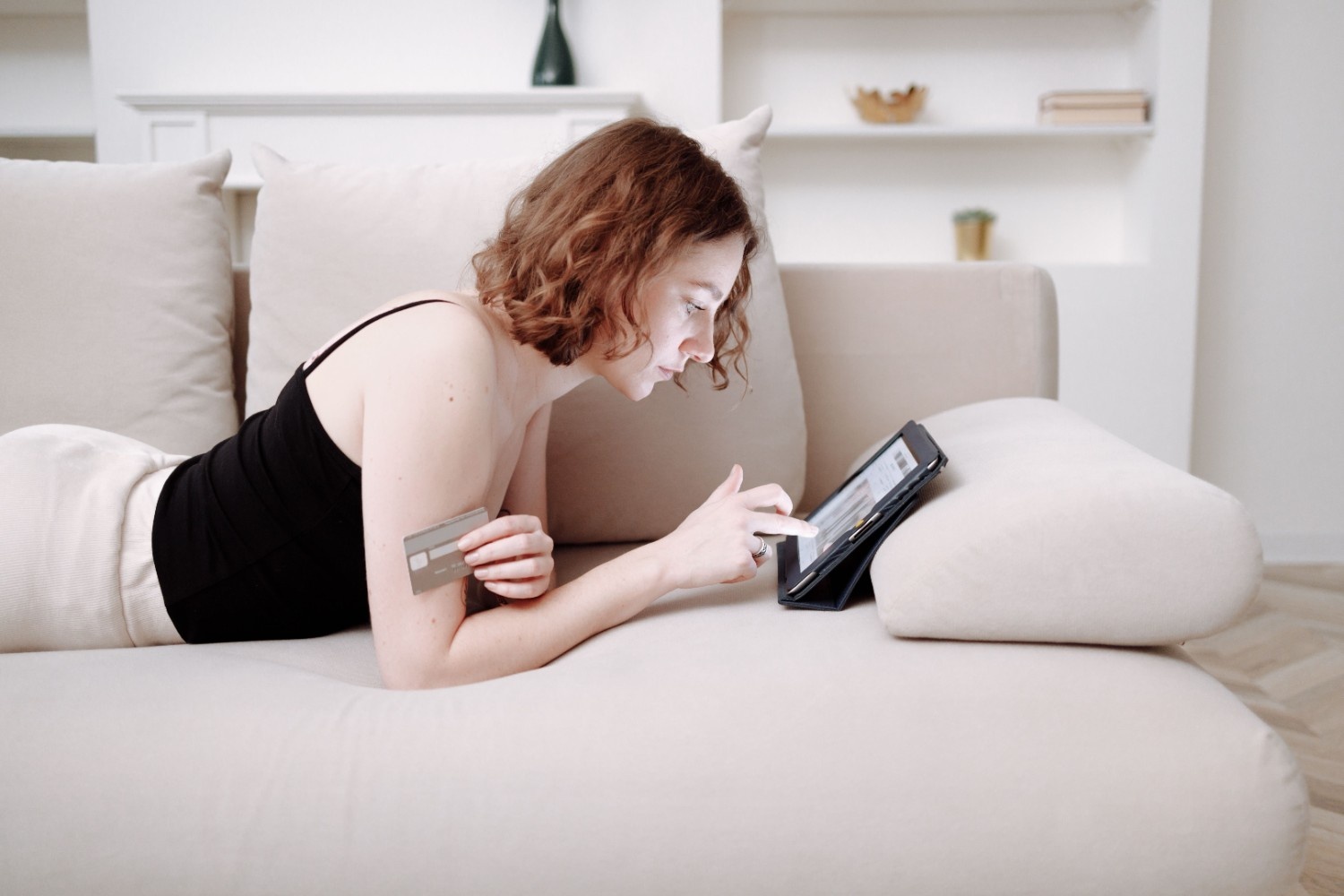 Woman comfortably shopping online for beginner sex toys from home