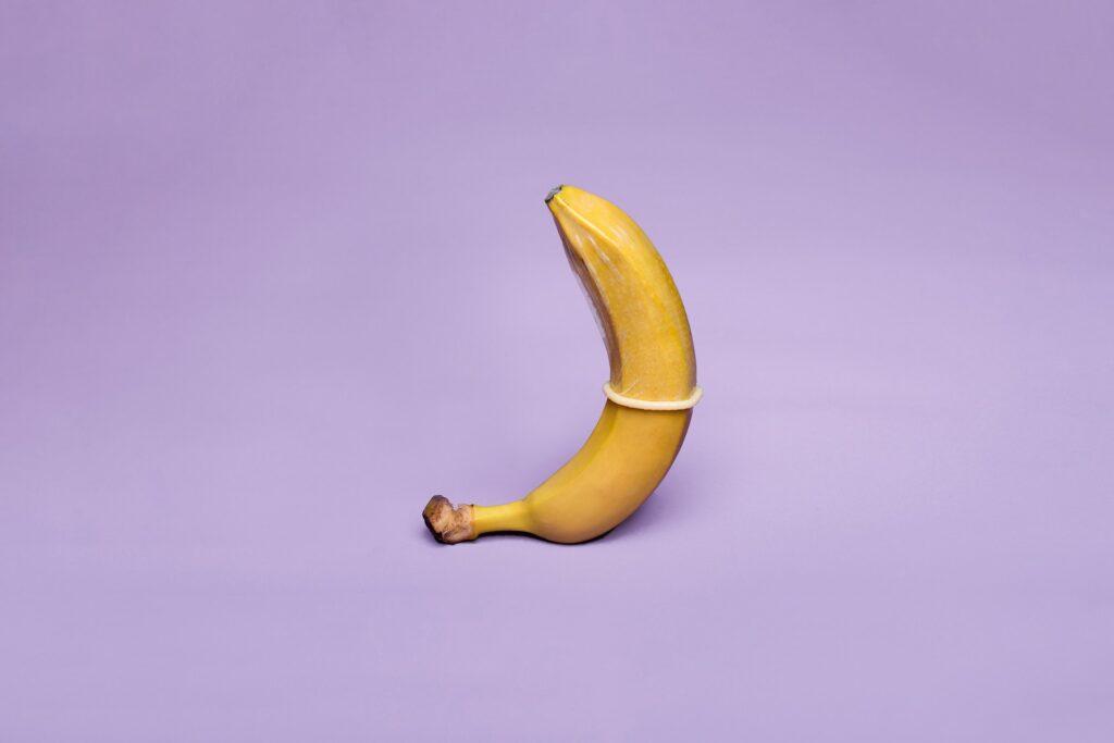 condom on banana with purple background